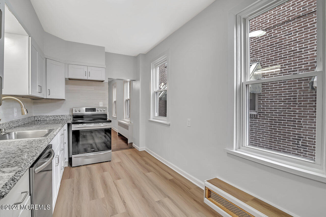 a kitchen with a stove a sink and a refrigerator