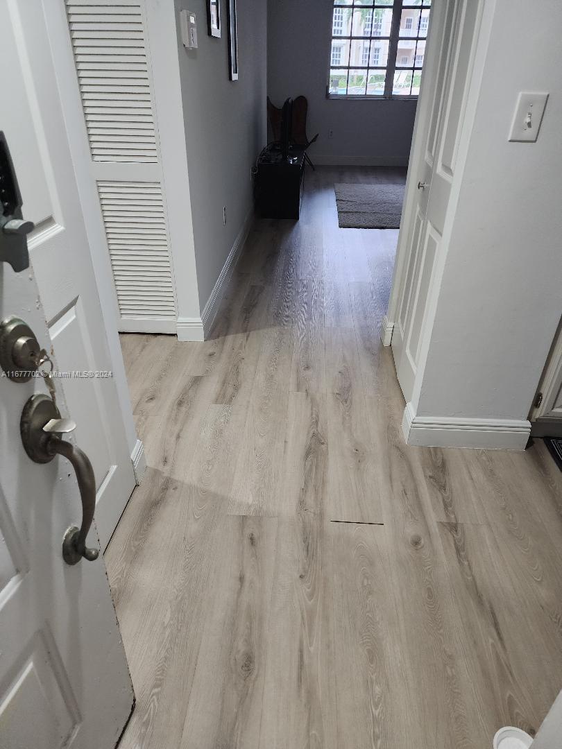 a view of entryway with wooden floor and stairs