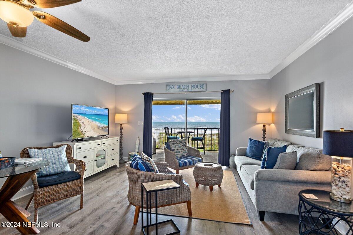 a living room with furniture fireplace and a large window