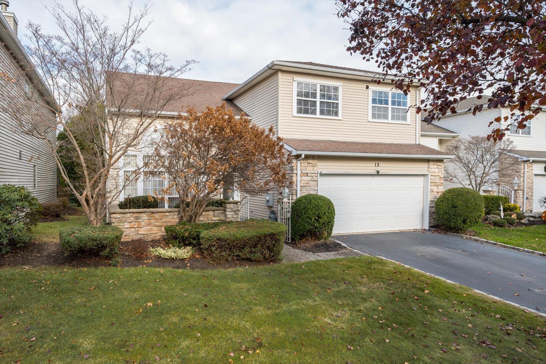 Front of property with a garage and a front lawn