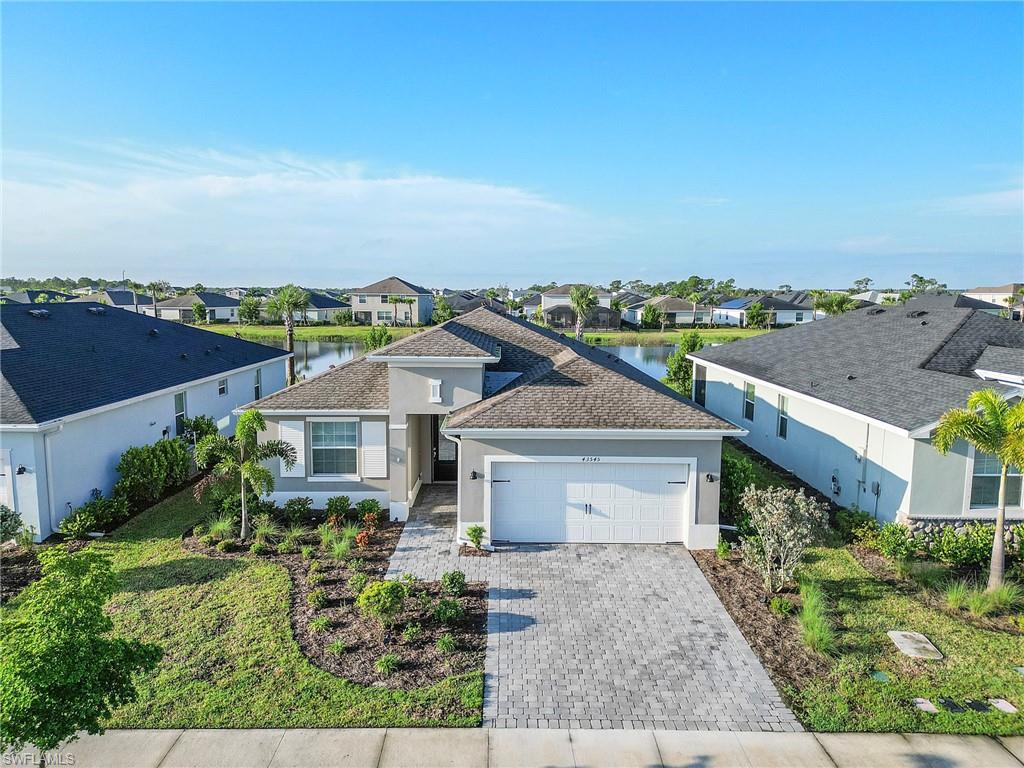 an aerial view of a house with a yard and plants