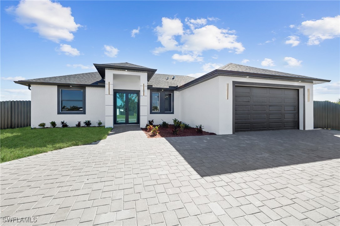 a view of a house with a yard and garage