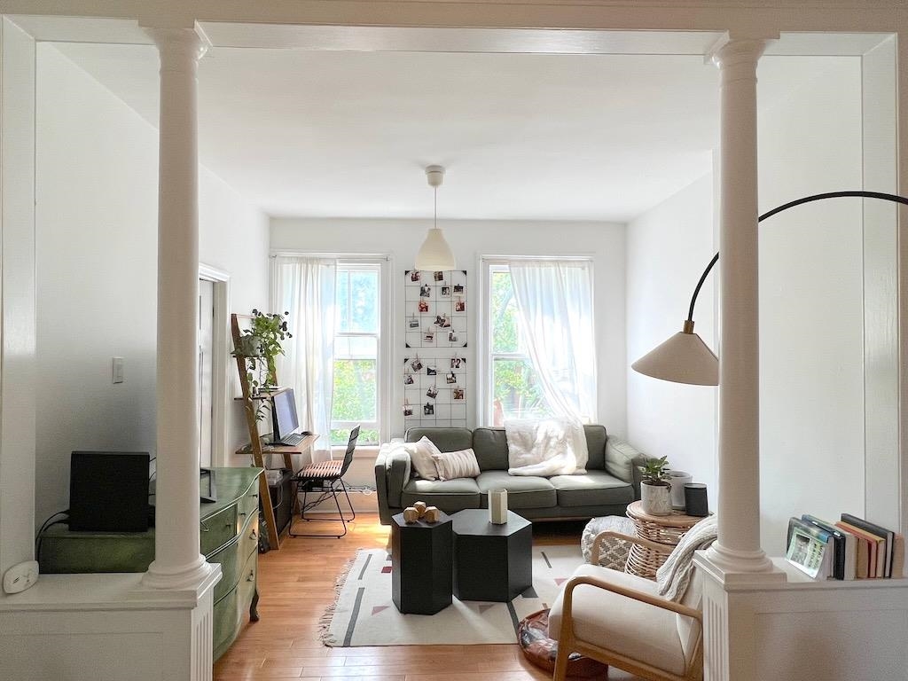 a living room with furniture and a large window