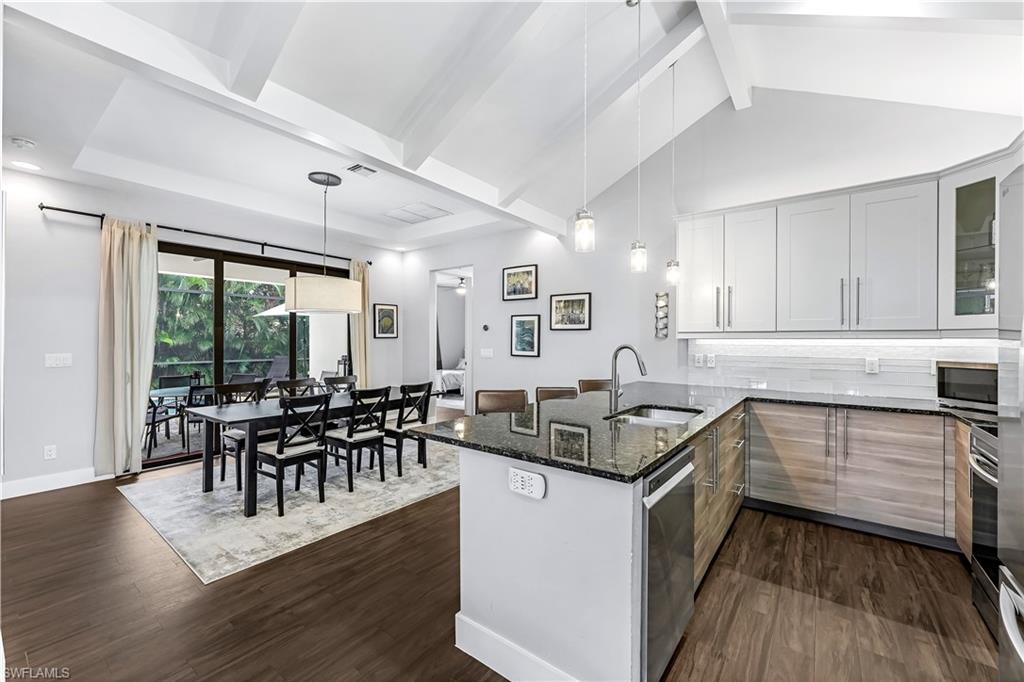 a kitchen with granite countertop furniture stove top oven and cabinets