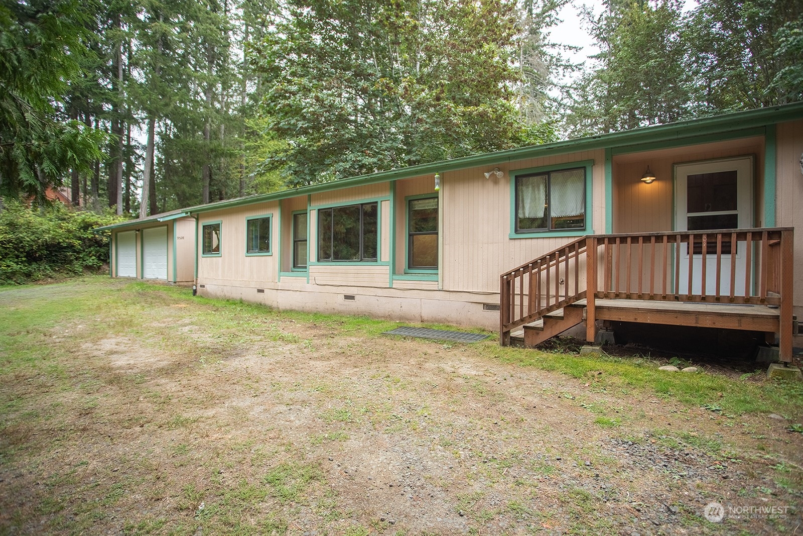 a view of a house with a yard and deck