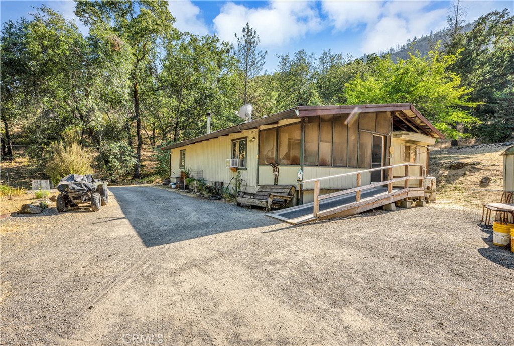 a view of a house with backyard and trees