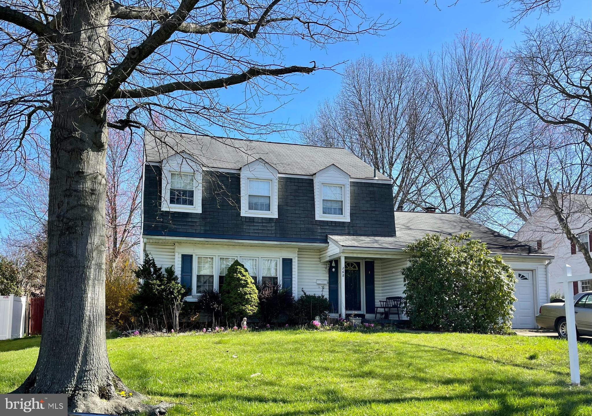 a view of a brick house with a yard