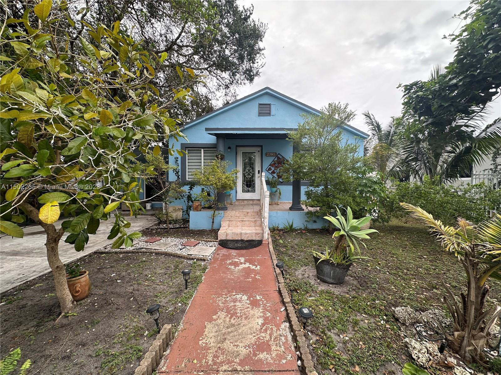 a front view of a house with garden