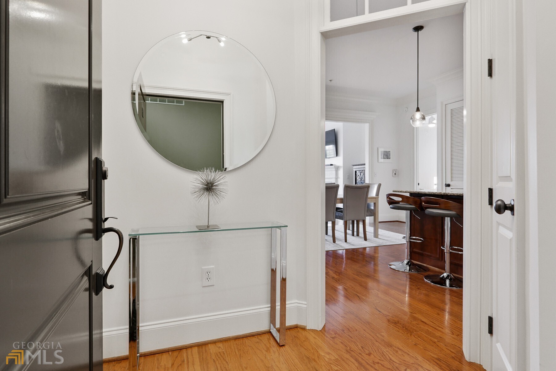 a view of a hallway with wooden floor and entryway