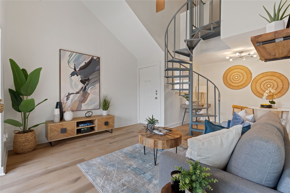 a living room with furniture a window and wooden floor