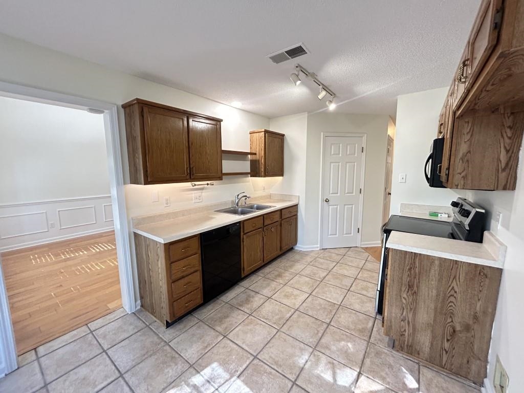 a kitchen with stainless steel appliances a sink and a refrigerator