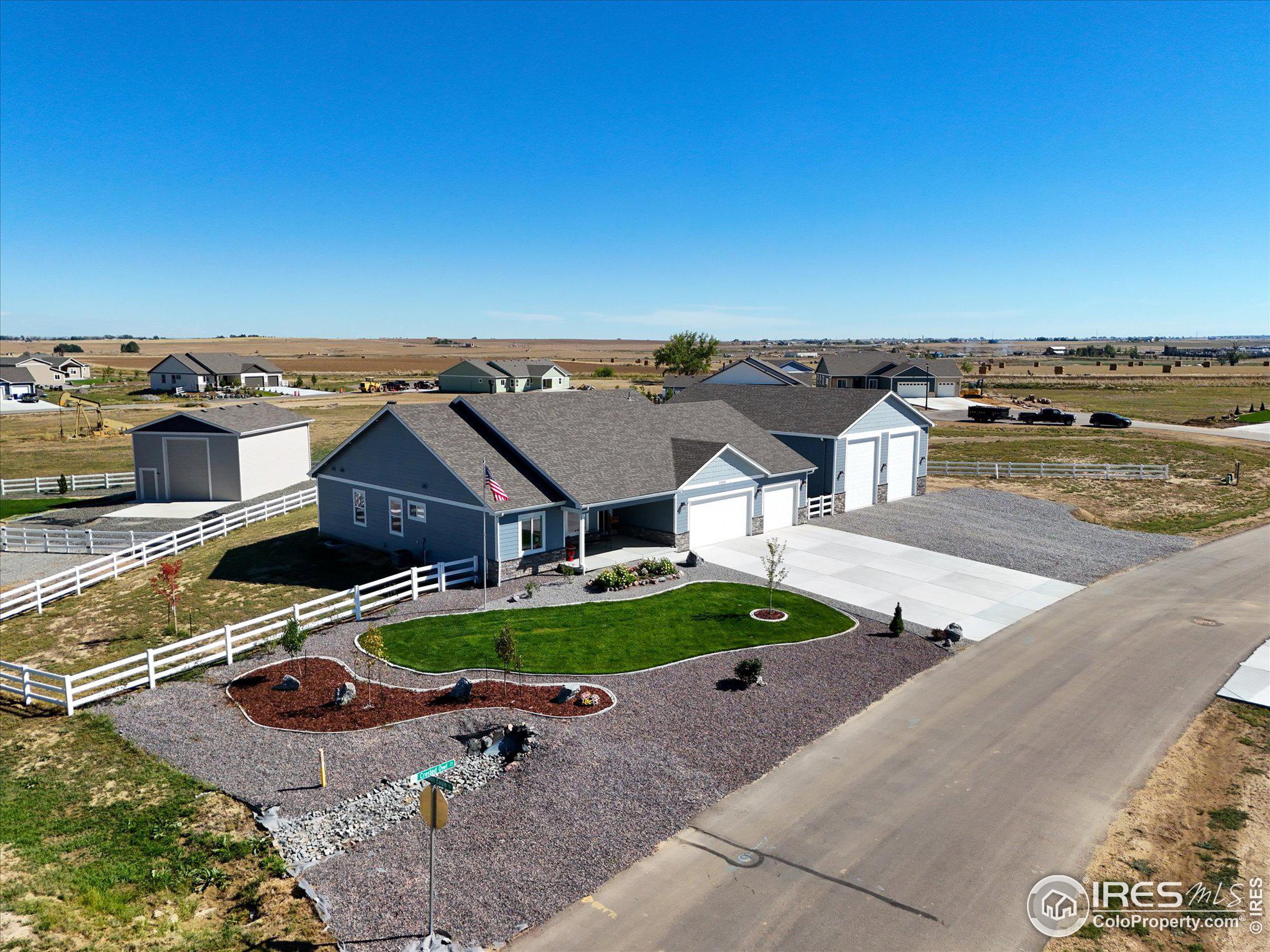 an aerial view of a house with yard basket ball court and outdoor seating