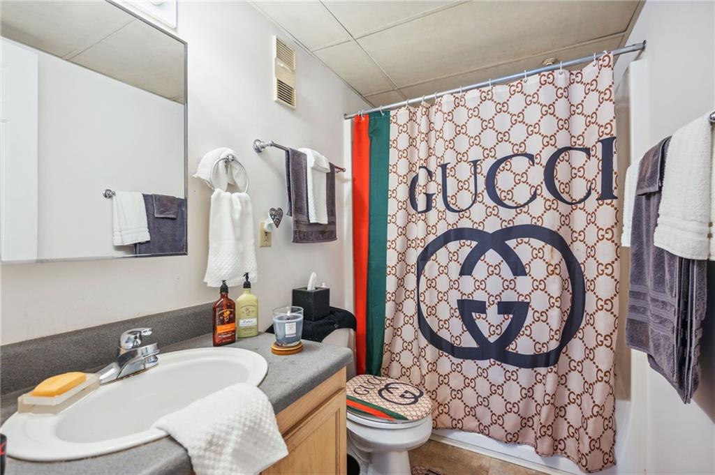 Beige and black gucci shower curtain bathroom set