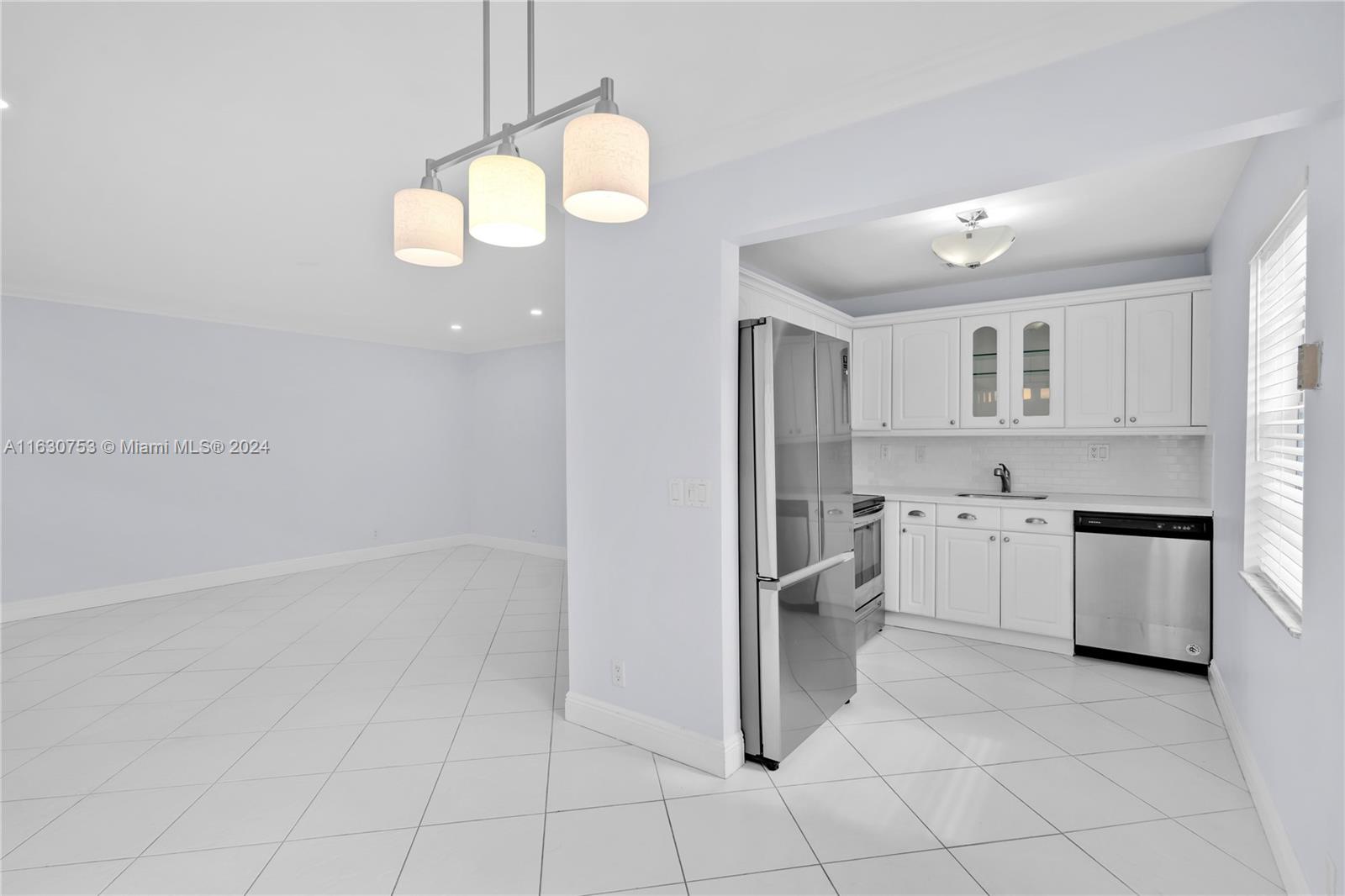 a kitchen with white cabinets and white appliances