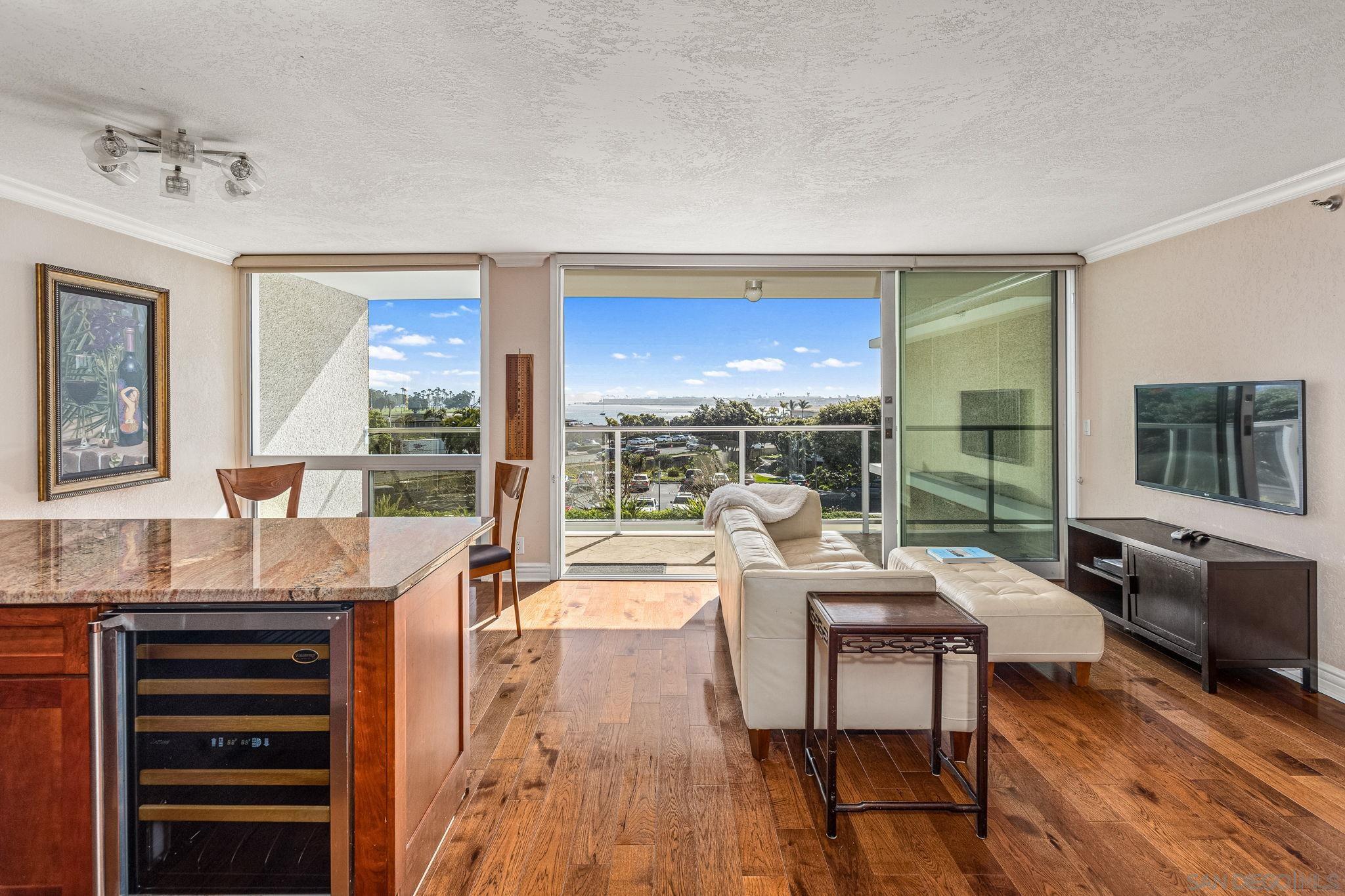 a living room with furniture and a floor to ceiling window