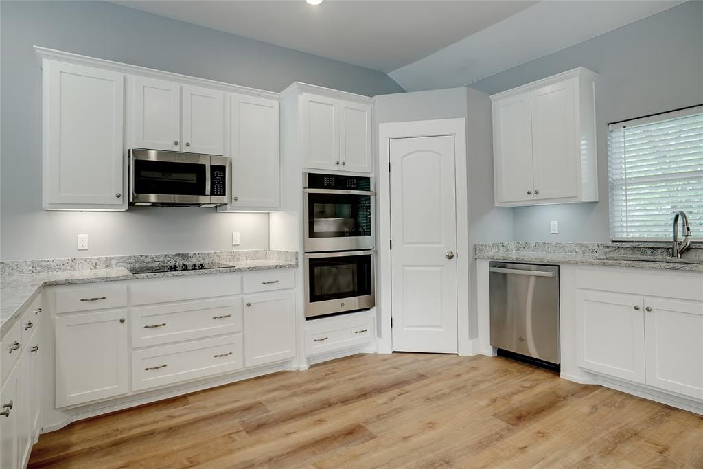 a kitchen with granite countertop a stove and a microwave