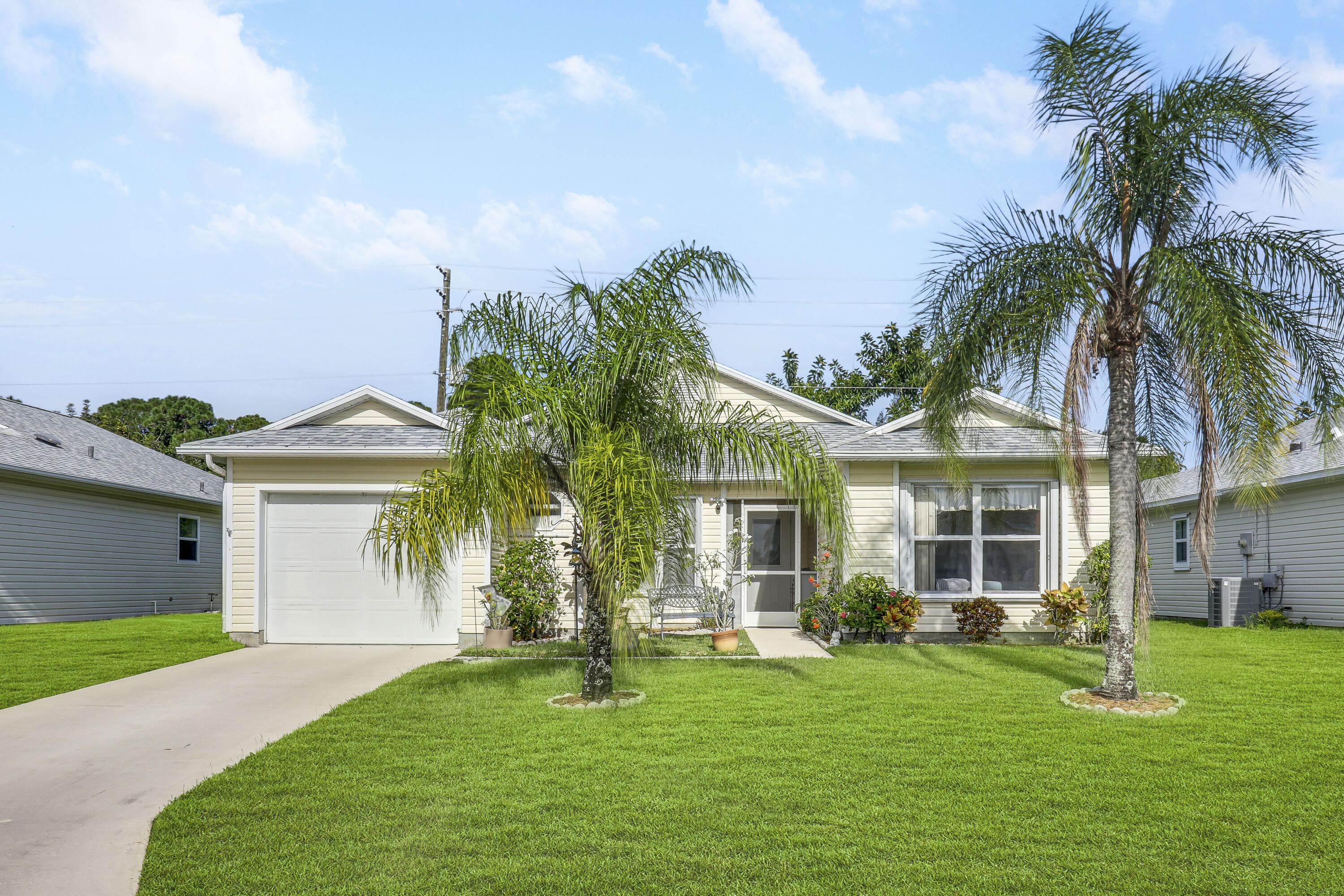 a front view of a house with a garden and yard