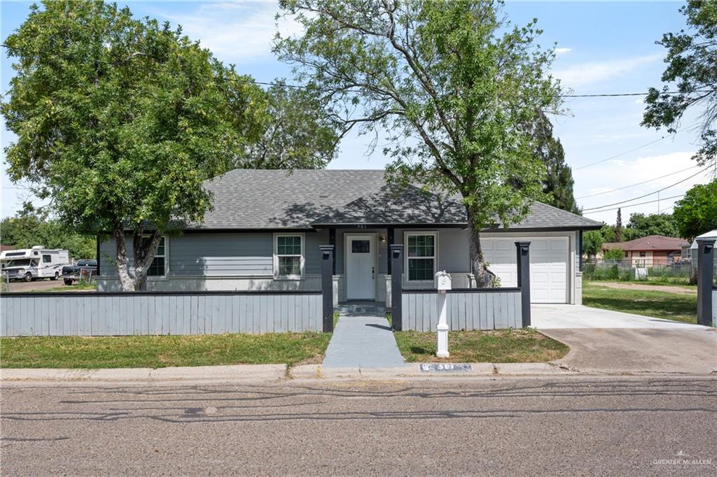 a front view of house with yard and trees