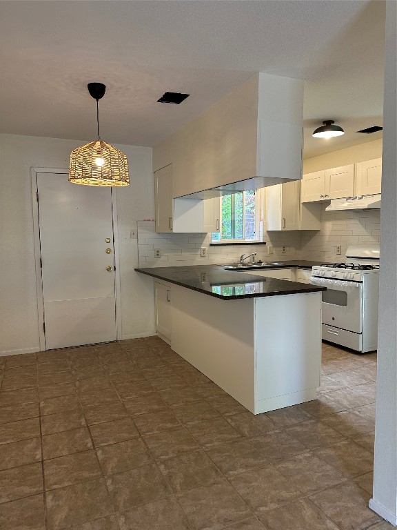 a kitchen with kitchen island granite countertop a sink a counter top space and cabinets