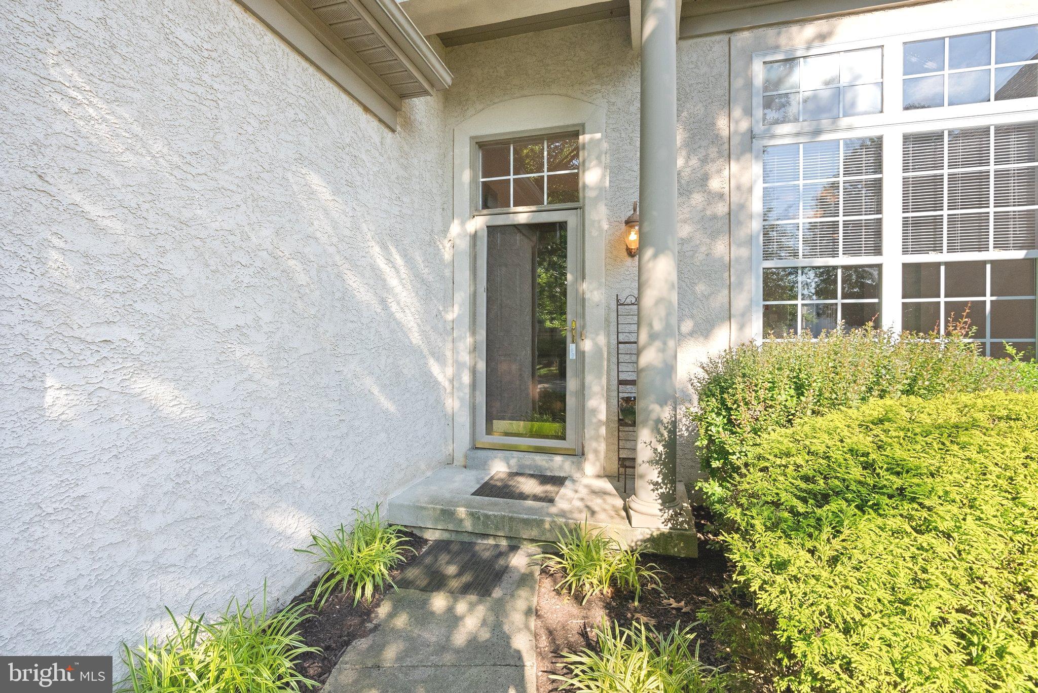 front view of a brick house with a large window