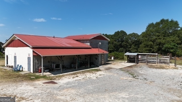 a view of a house with a yard and wooden fence