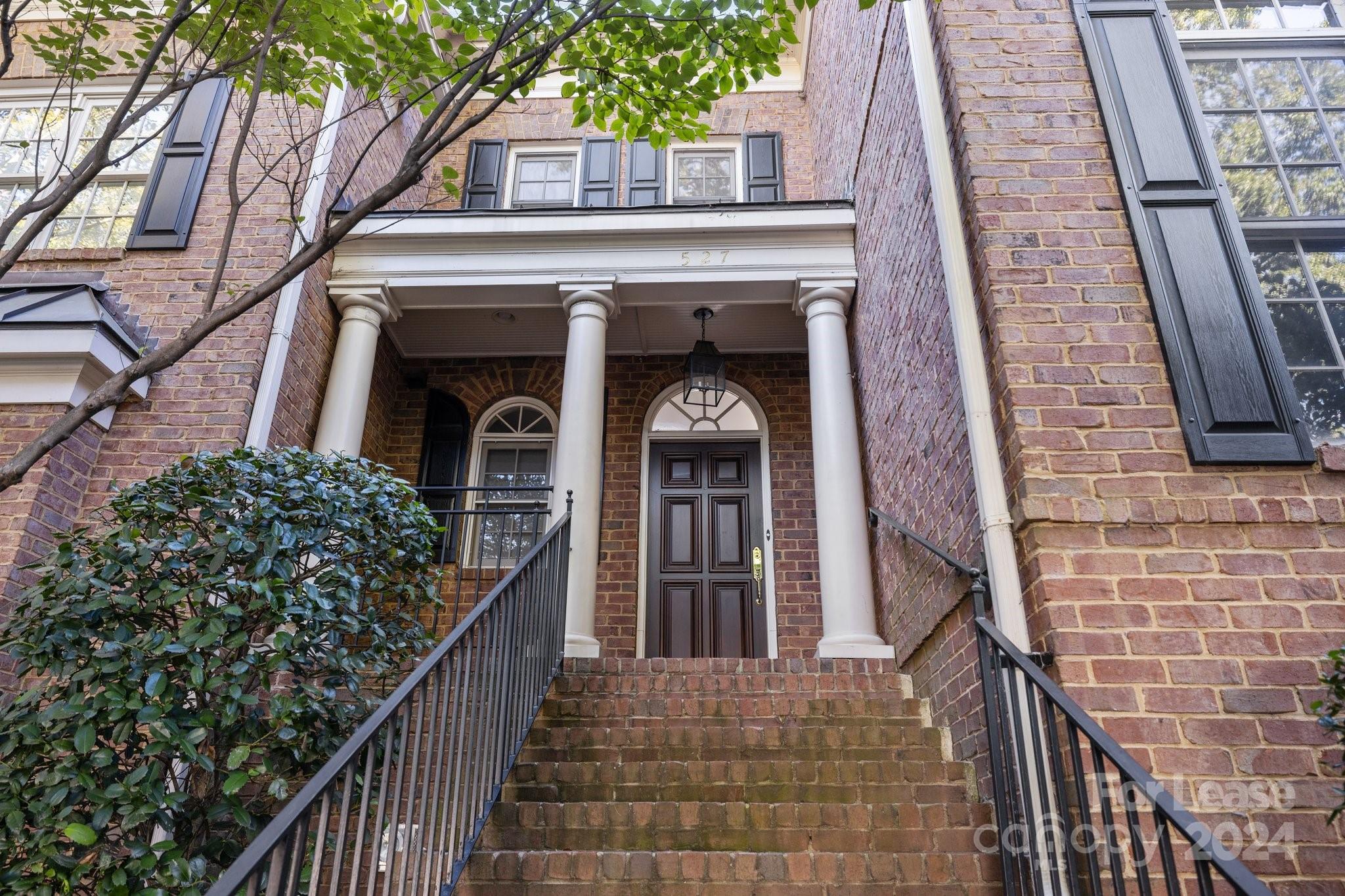 a view of a brick house with large windows