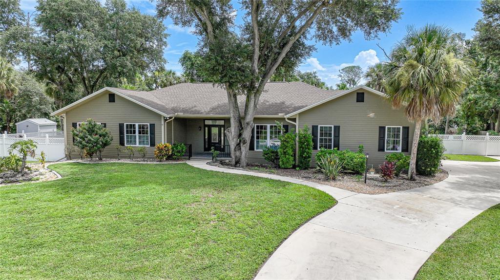 a front view of a house with yard and green space