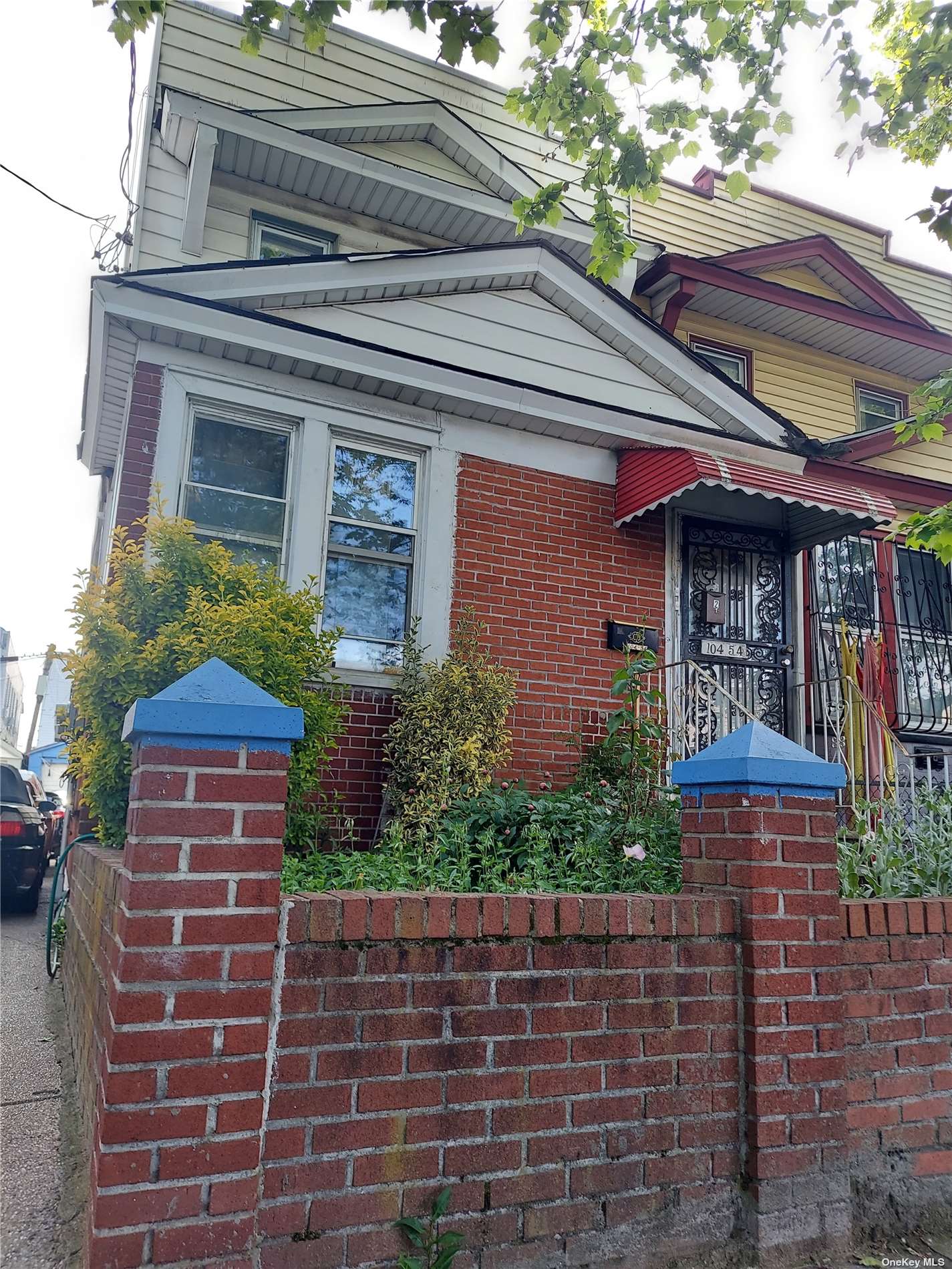 a front view of a house with plants