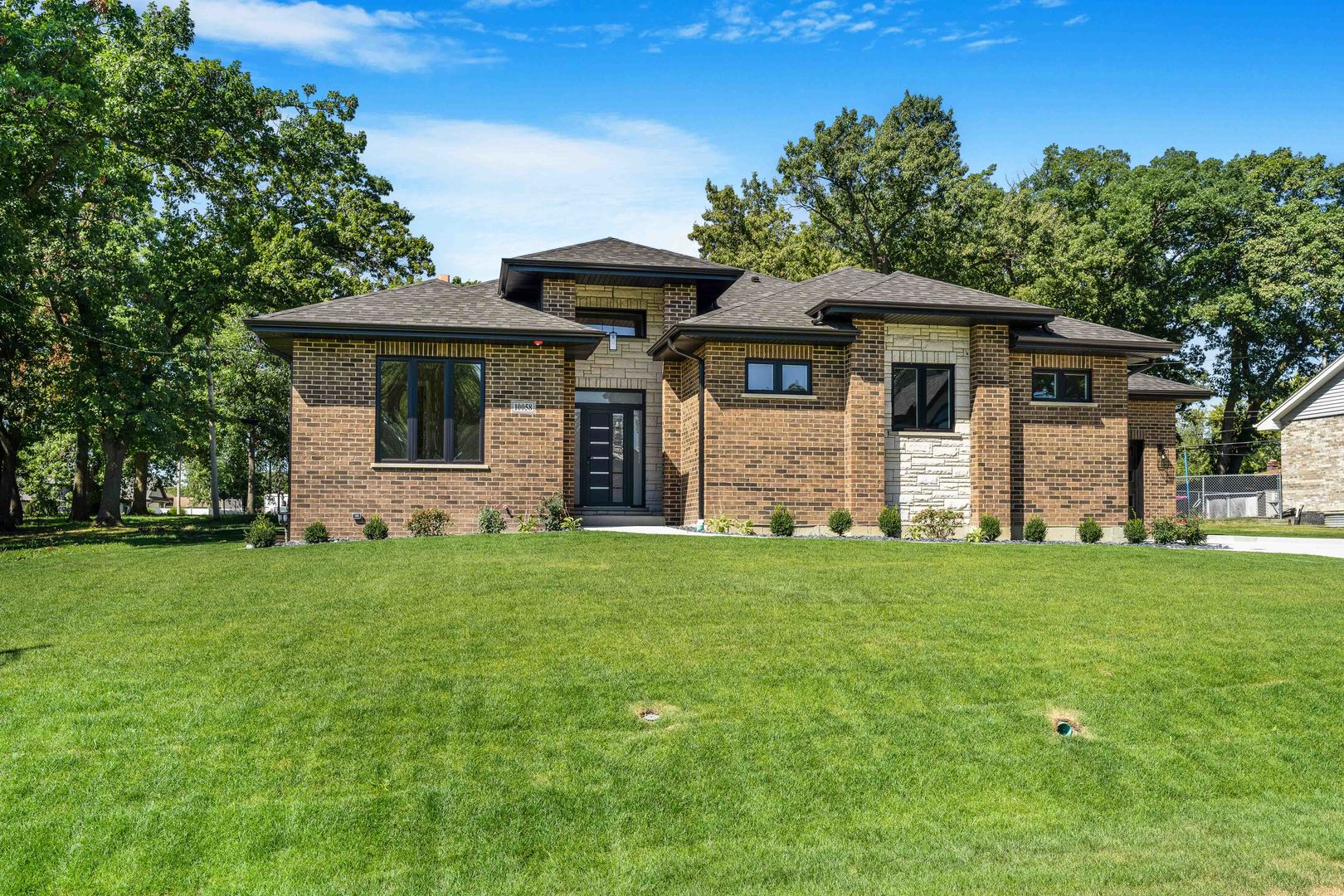 a front view of a house with a garden