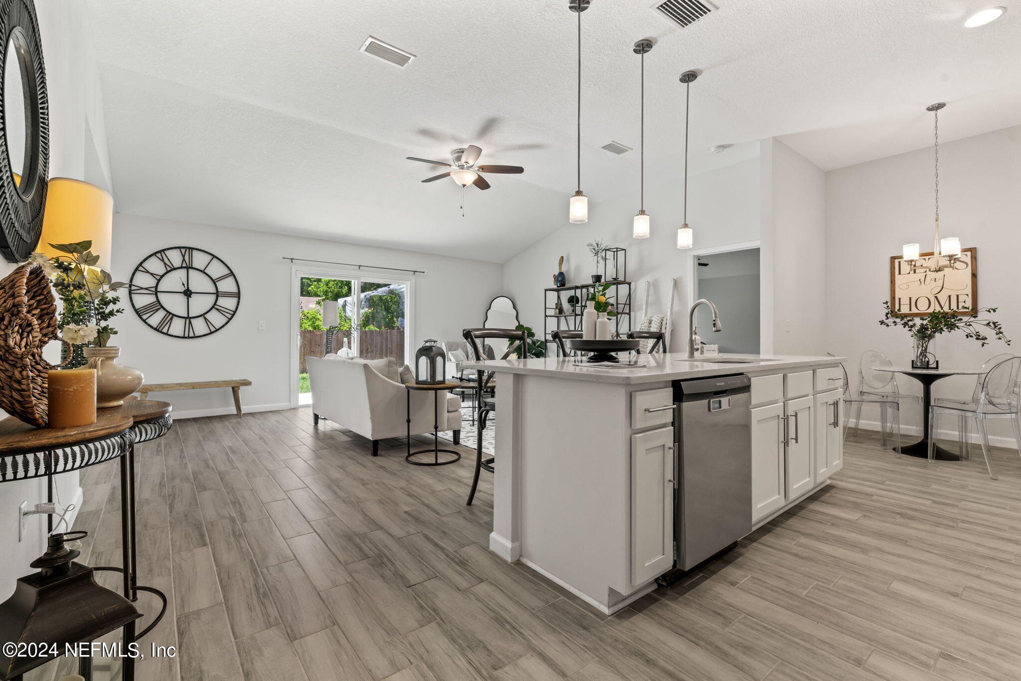 a kitchen with sink cabinets and wooden floor