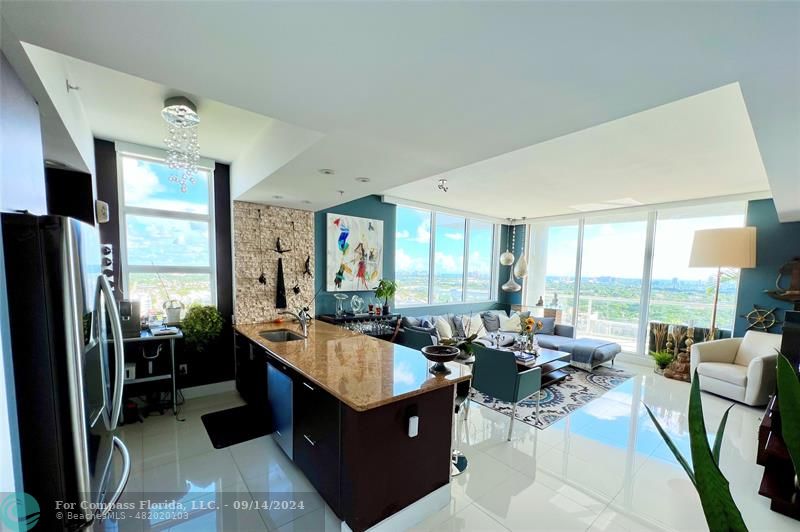 a very nice looking living room with a large window and furniture