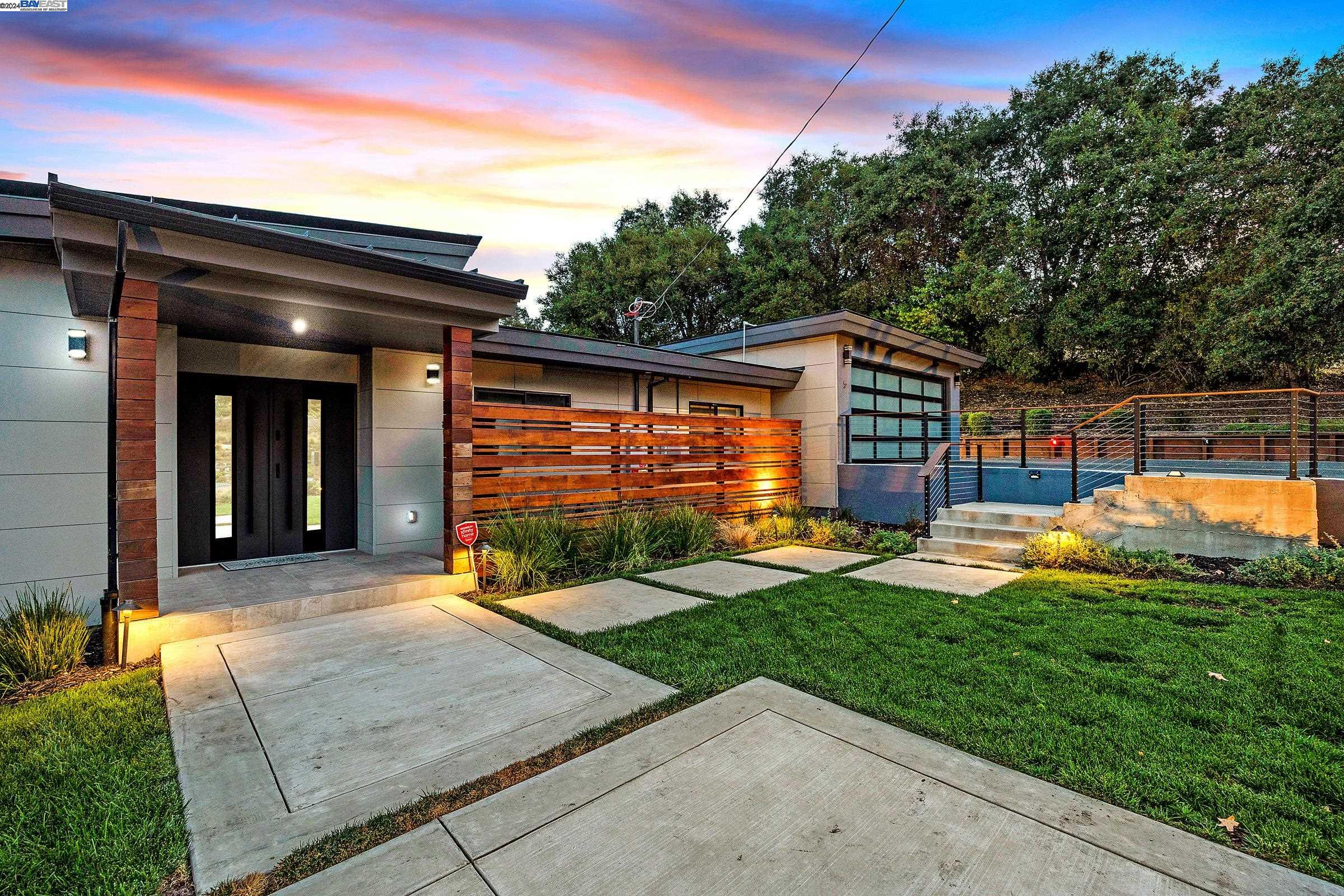 a view of a house with backyard and porch