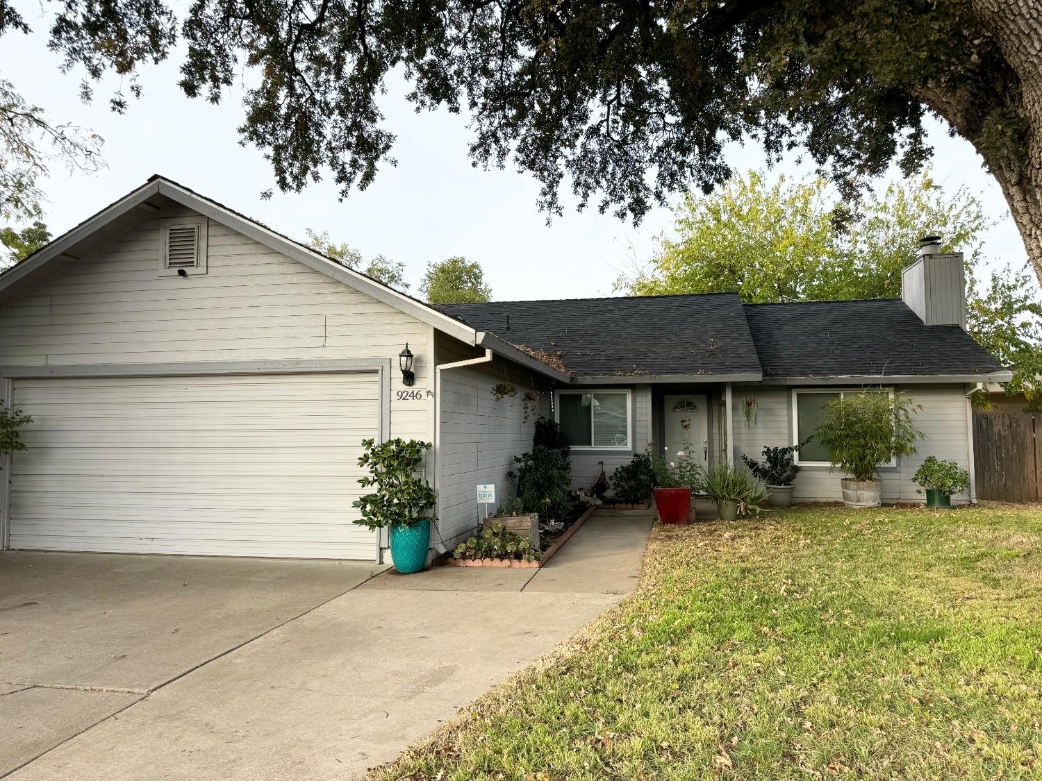 a front view of a house with a yard and seating space