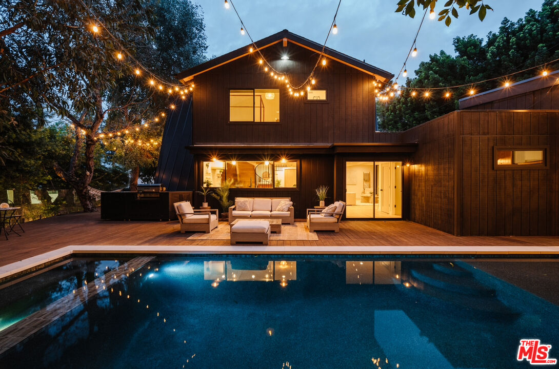 a view of a house with backyard and sitting area