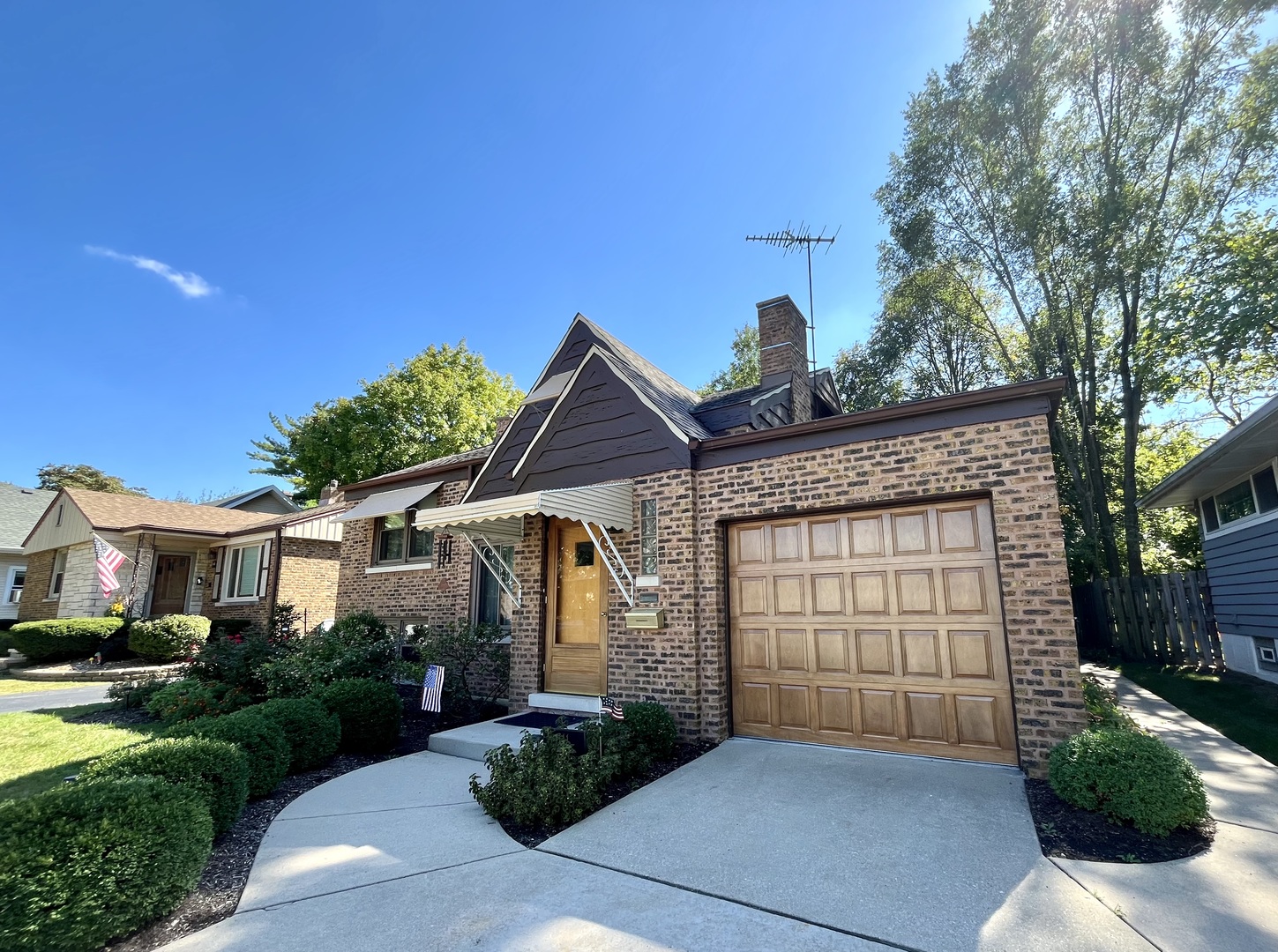 a front view of a house with a garden