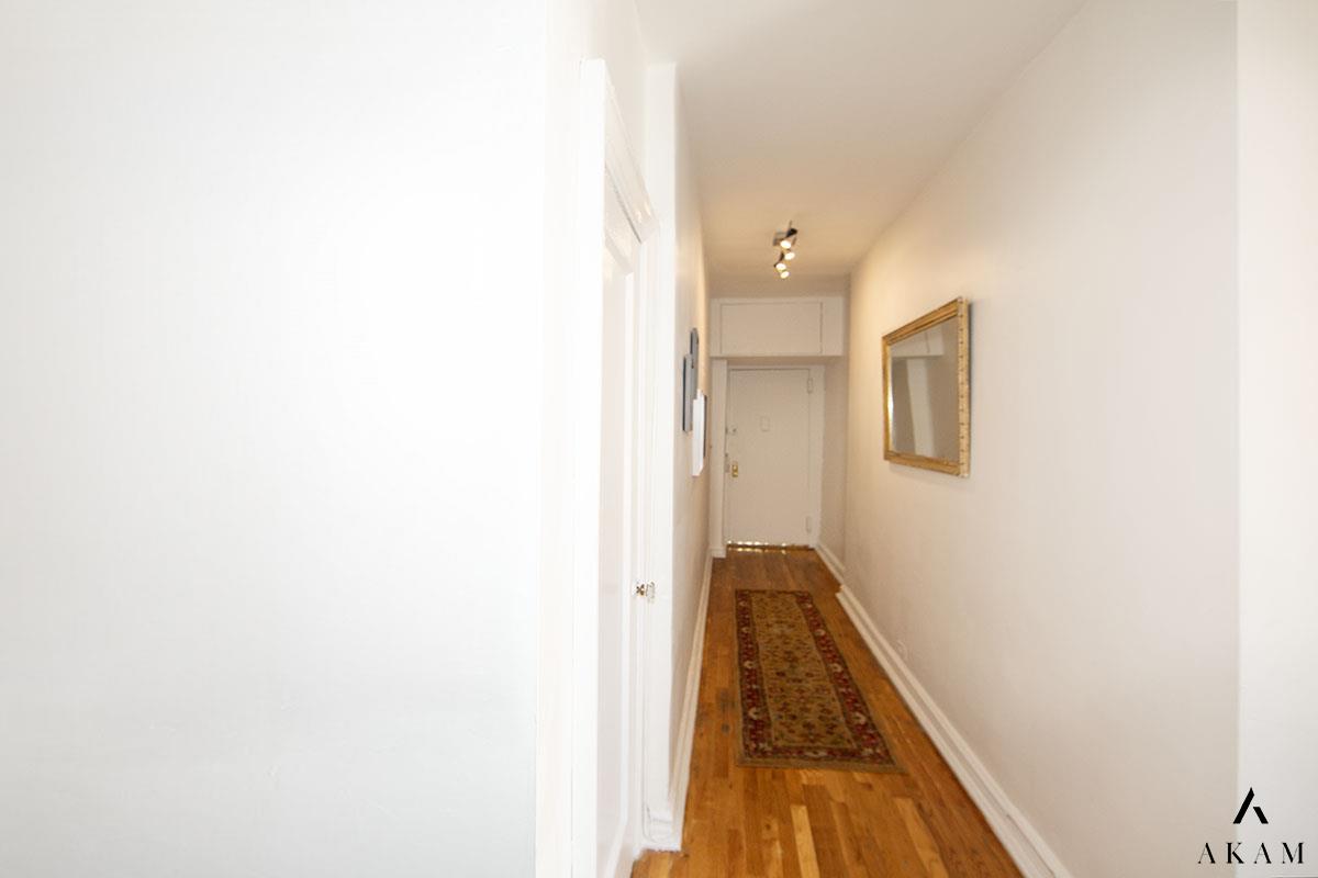 a view of a hallway with white walls