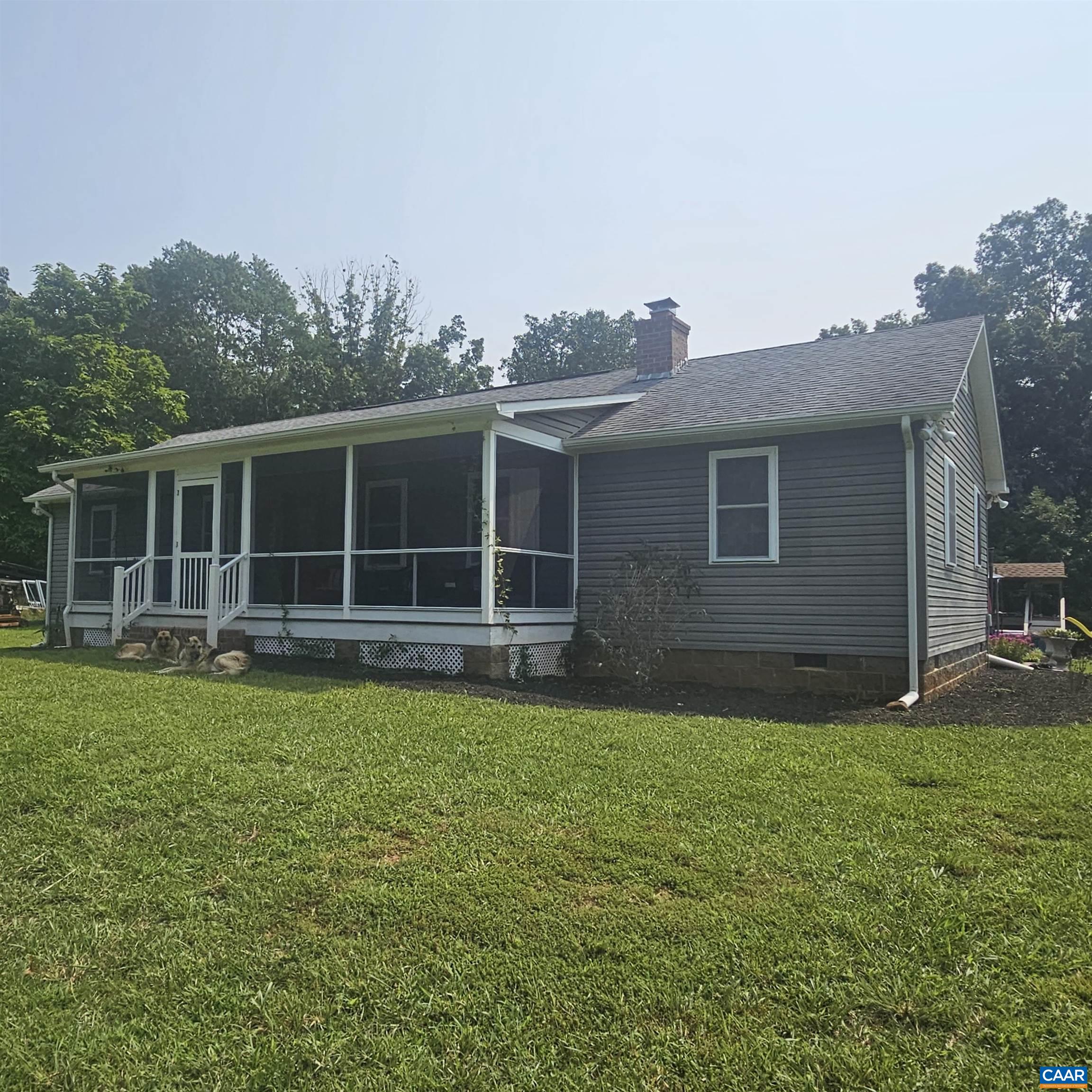 a view of a house with a backyard