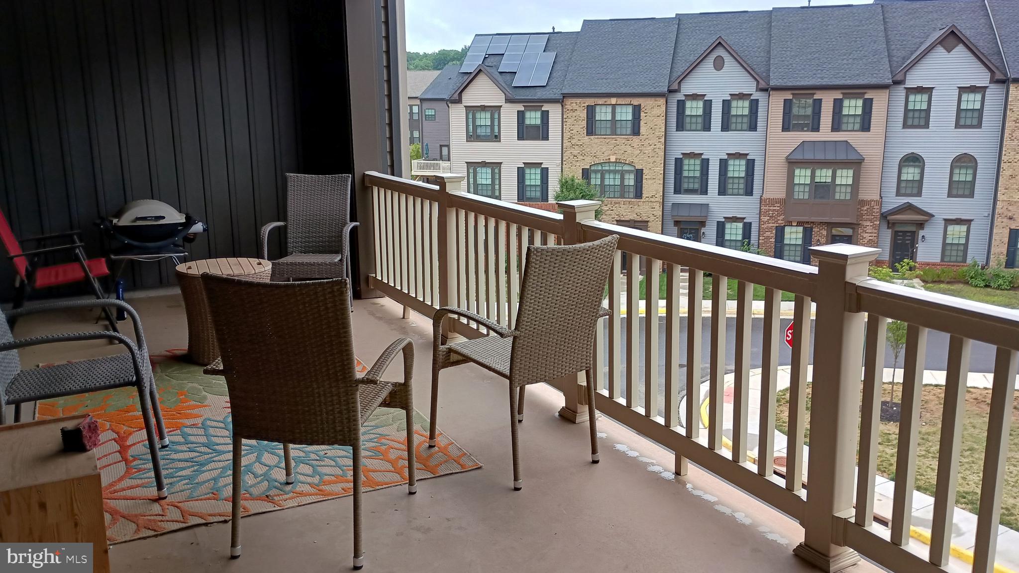 a view of a chairs and table in the balcony