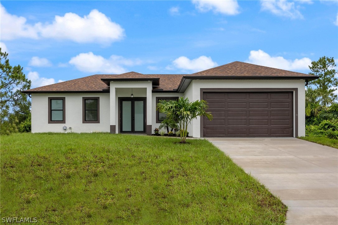 a front view of a house with a garden and yard