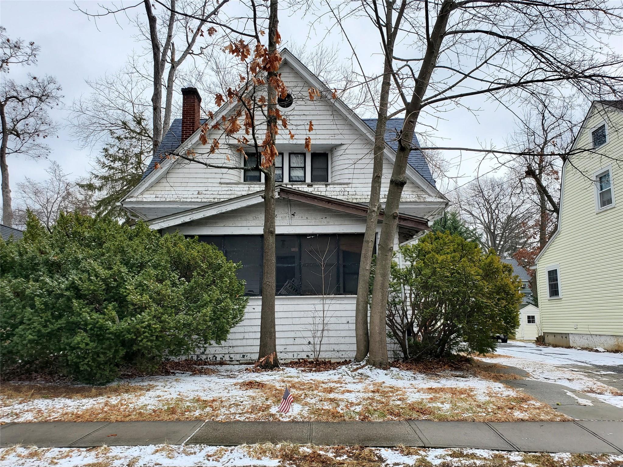 View of snow covered exterior with a sunroom