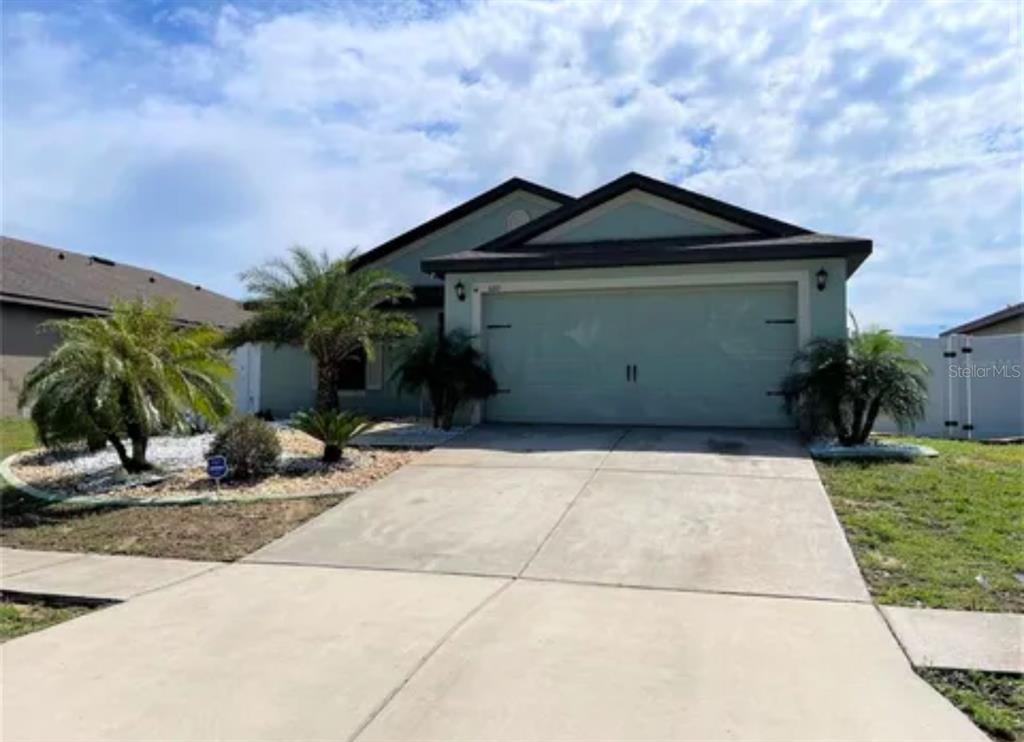 a front view of a house with garage