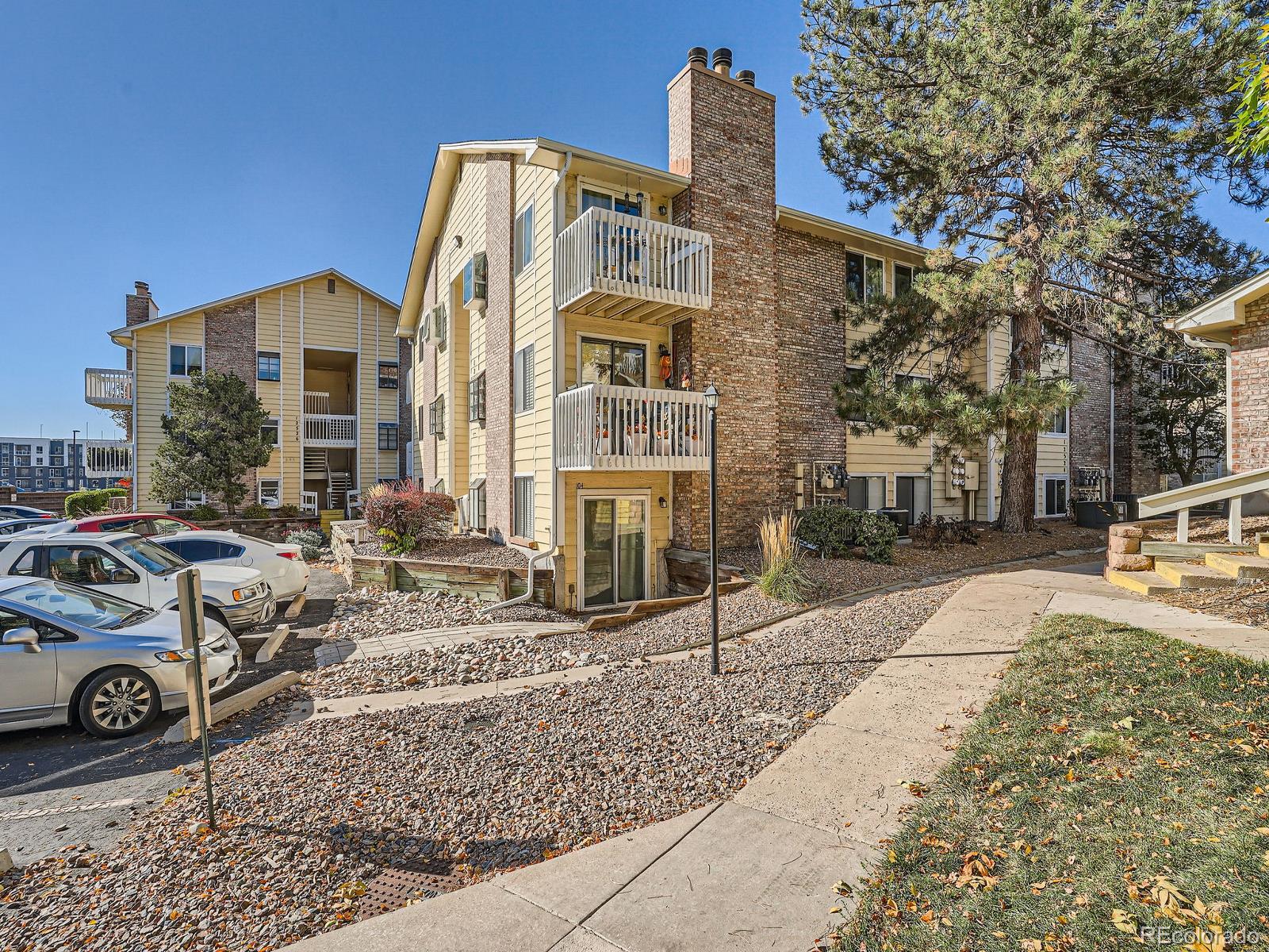 a front view of a residential apartment building with a yard