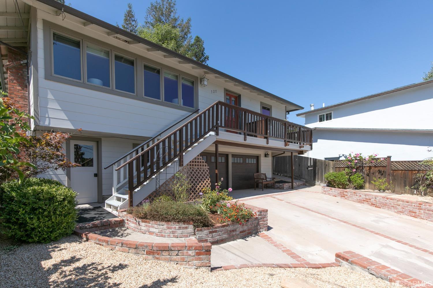 a view of a house with entrance stairs and a yard