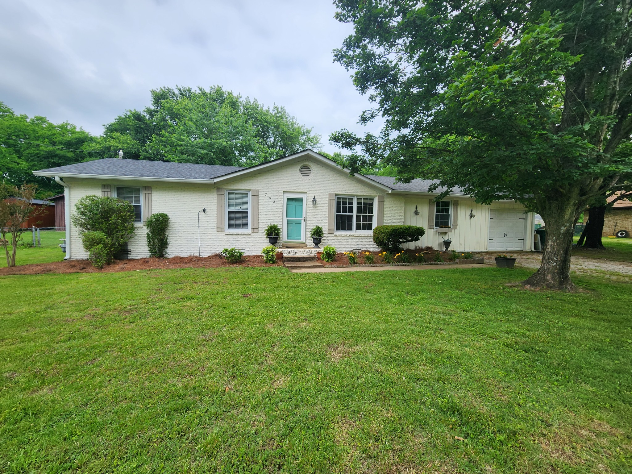 a front view of house with yard and green space