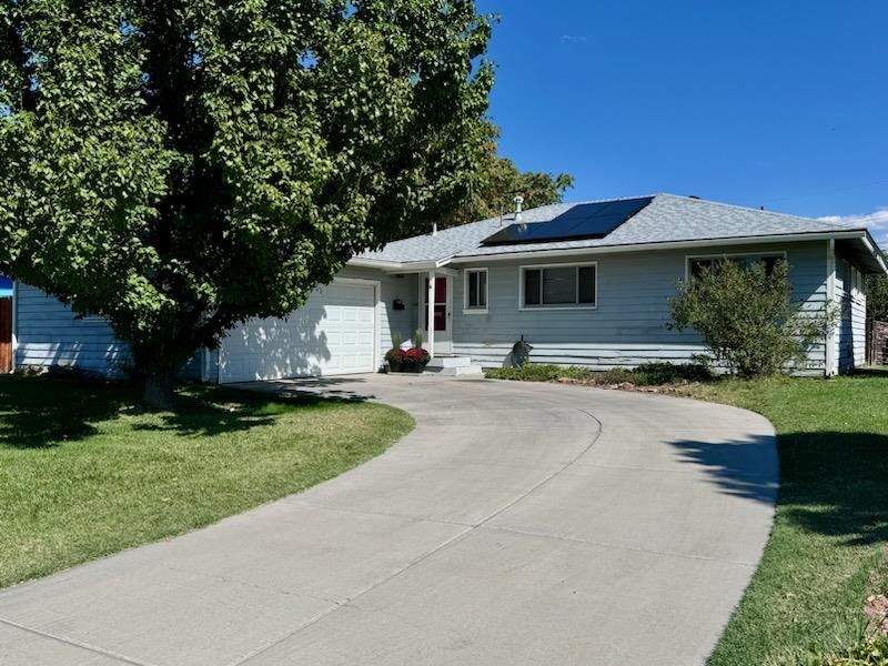 a front view of a house with yard patio and green space