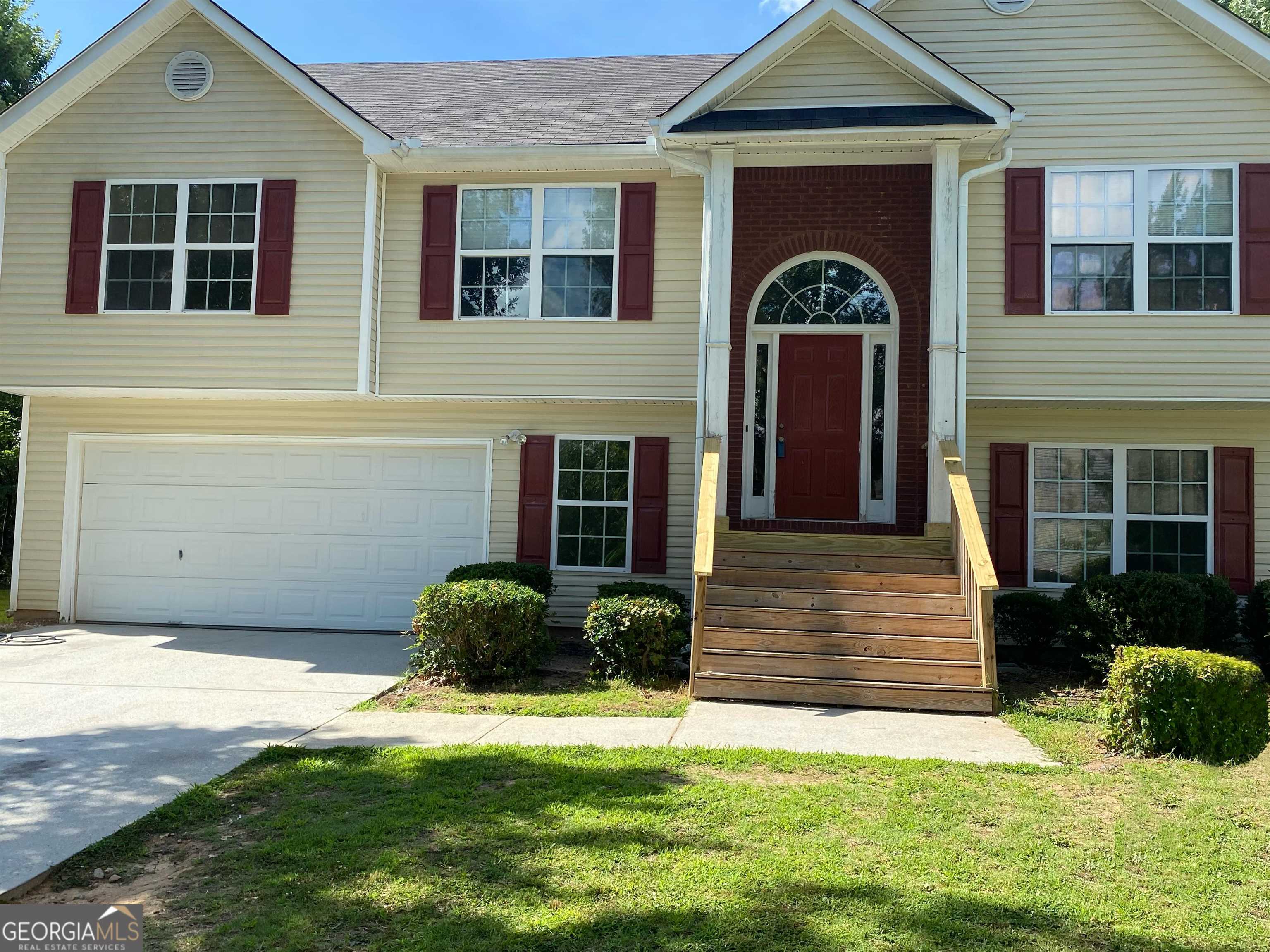 a front view of a house with a yard