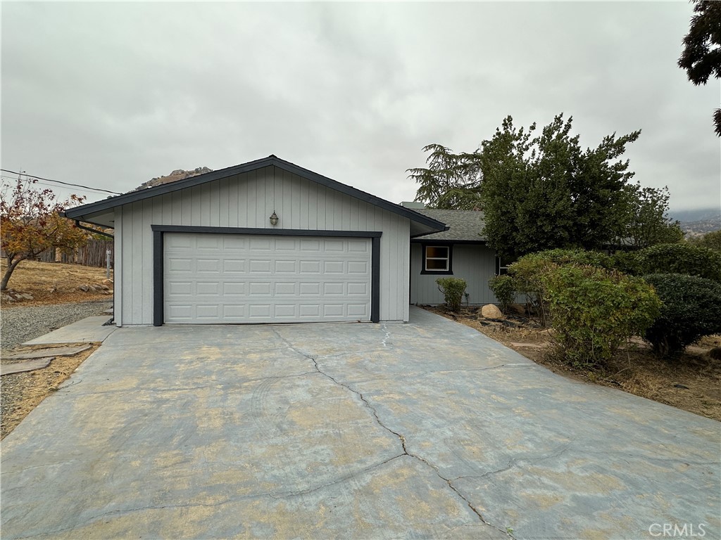 a view of garage yard and tree