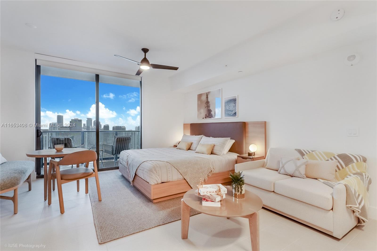 a bedroom with furniture and a large window