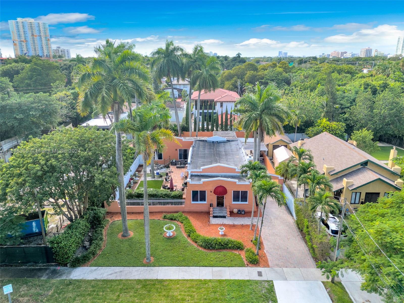 a aerial view of a house with swimming pool garden and patio