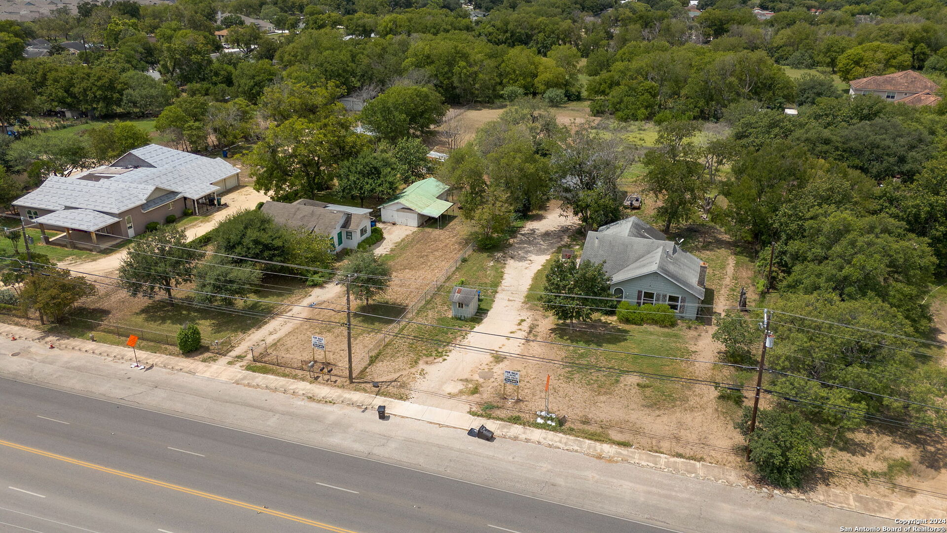 an aerial view of houses with yard